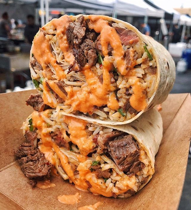 two burritos with meat and cheese on top