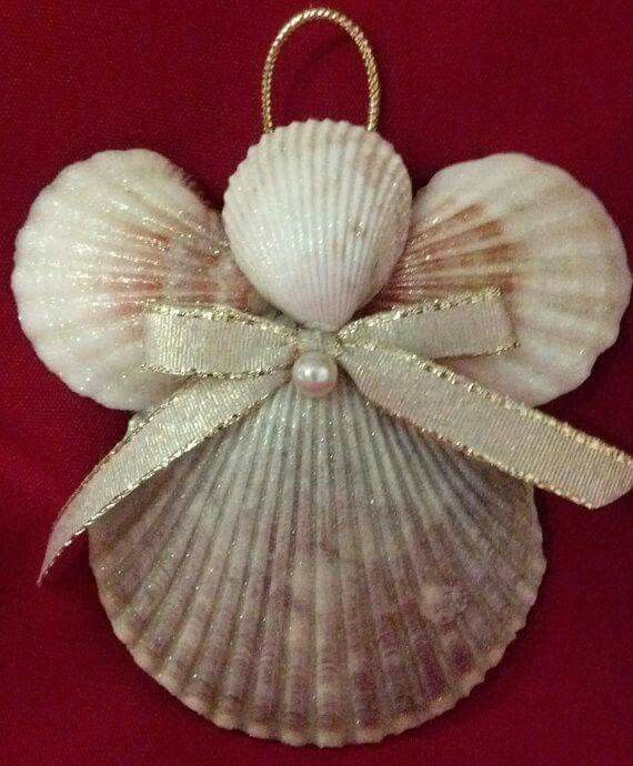 an ornament with a bow on top of it and a pearl in the middle