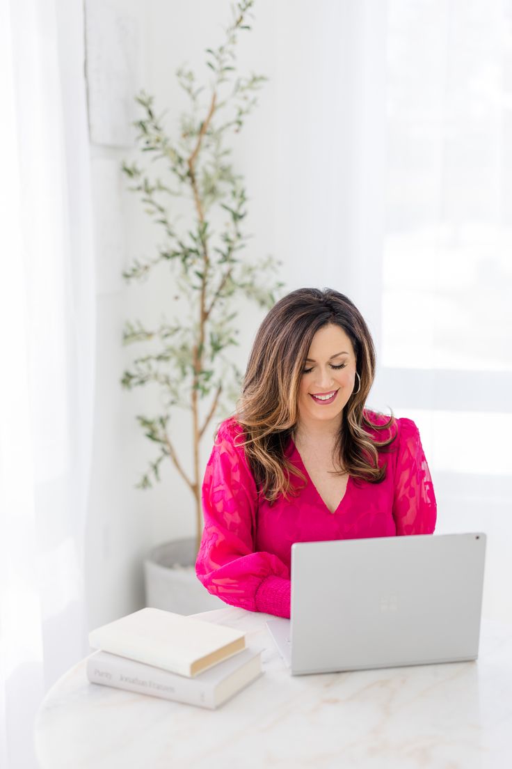 Business coach at photoshoot wearing bright pink dress working on computer at desk in white photo studio Career Coach Photoshoot, Life Coach Pictures, Mindset Coach Photoshoot, Business Coach Branding Photos, Life Coaching Photoshoot, Coaching Branding Photography, Female Branding Photoshoot, Life Coach Branding Photos, Editorial Branding Photography