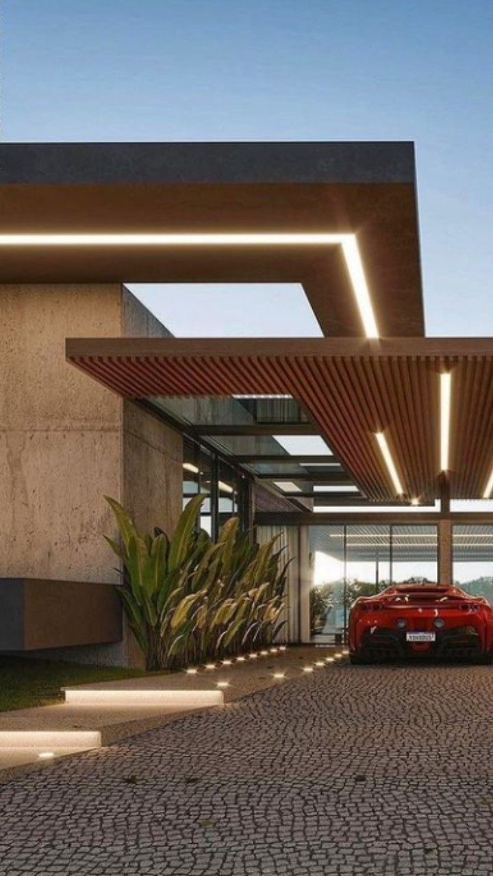 a red sports car is parked in front of a modern house with an awning