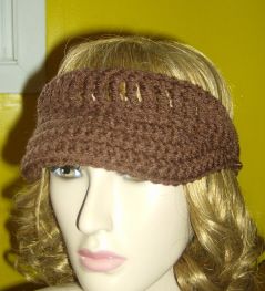 a mannequin head wearing a brown crochet knitted earwarmer