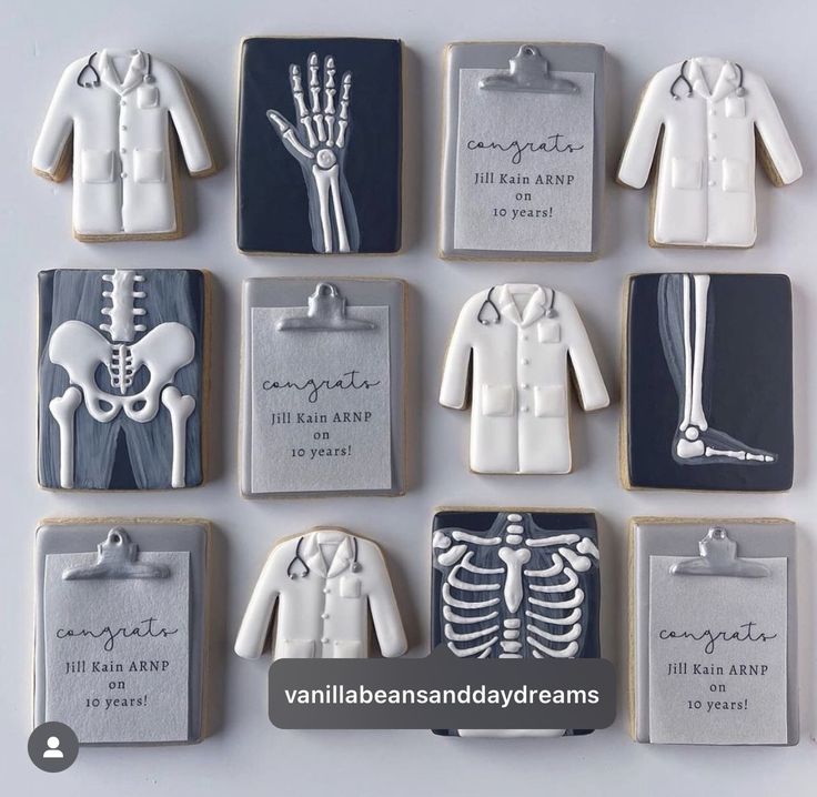 decorated cookies are arranged in the shape of human bones and skeleton images, with names on them