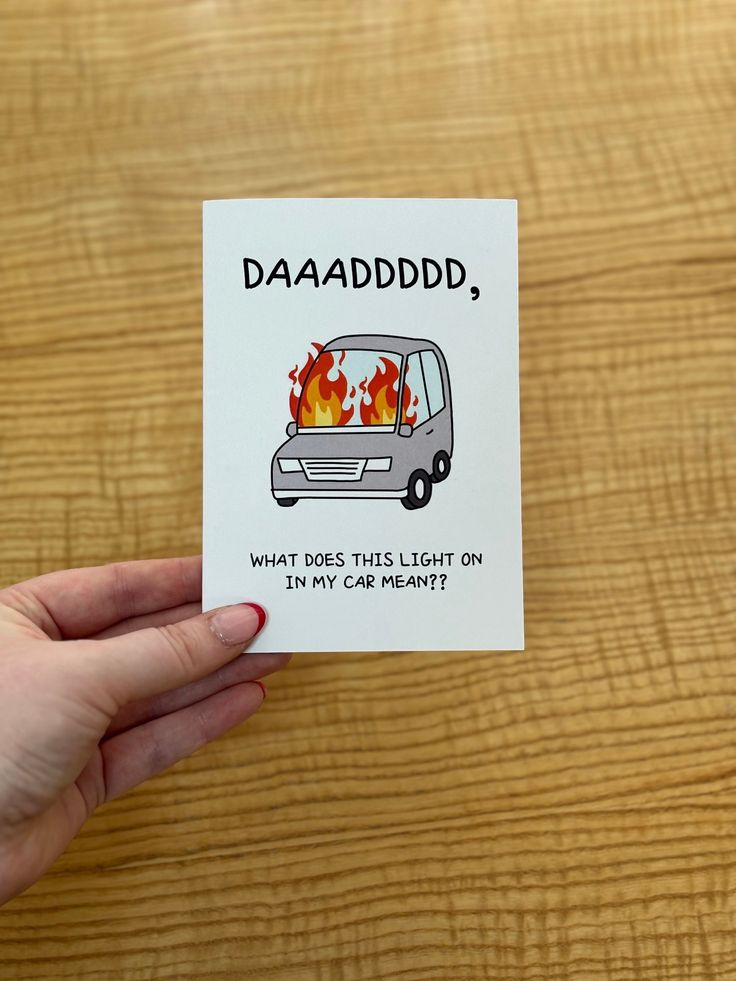 a hand holding up a card with a van on it