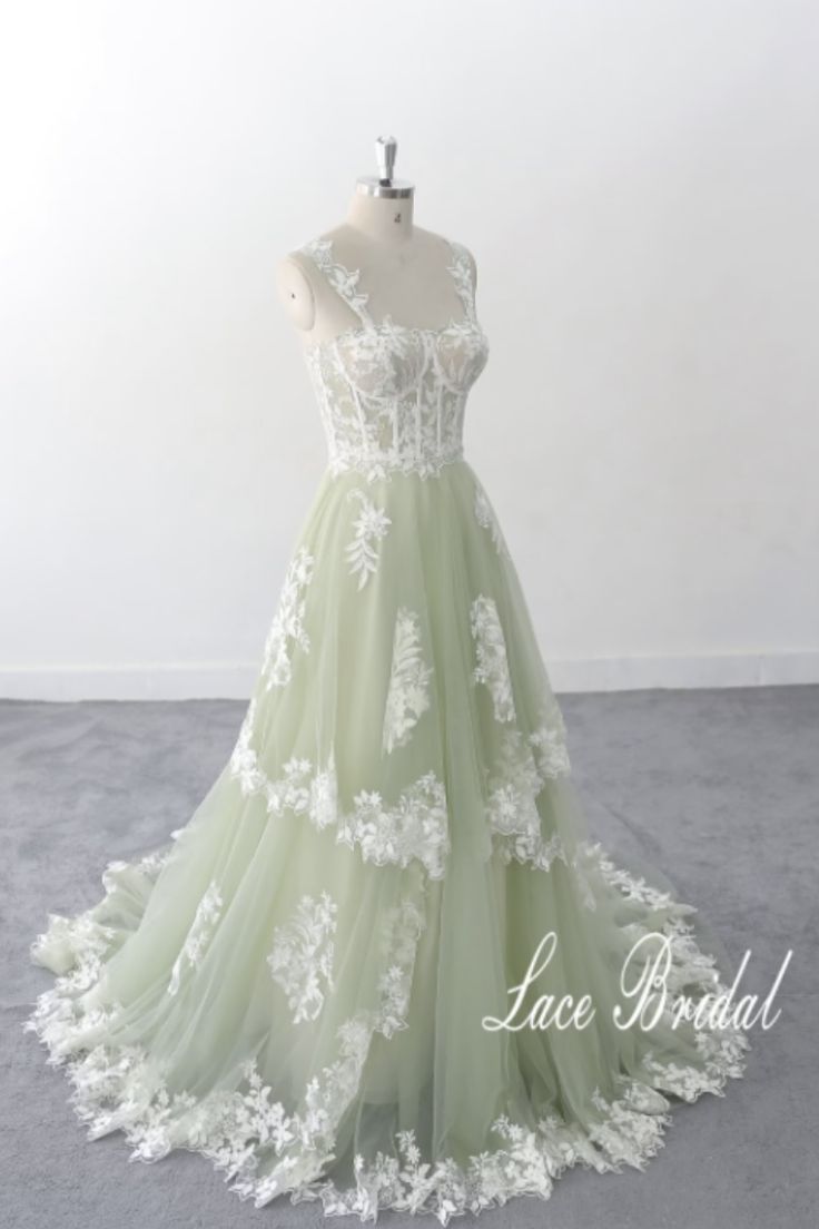 a green and white wedding dress on a mannequin