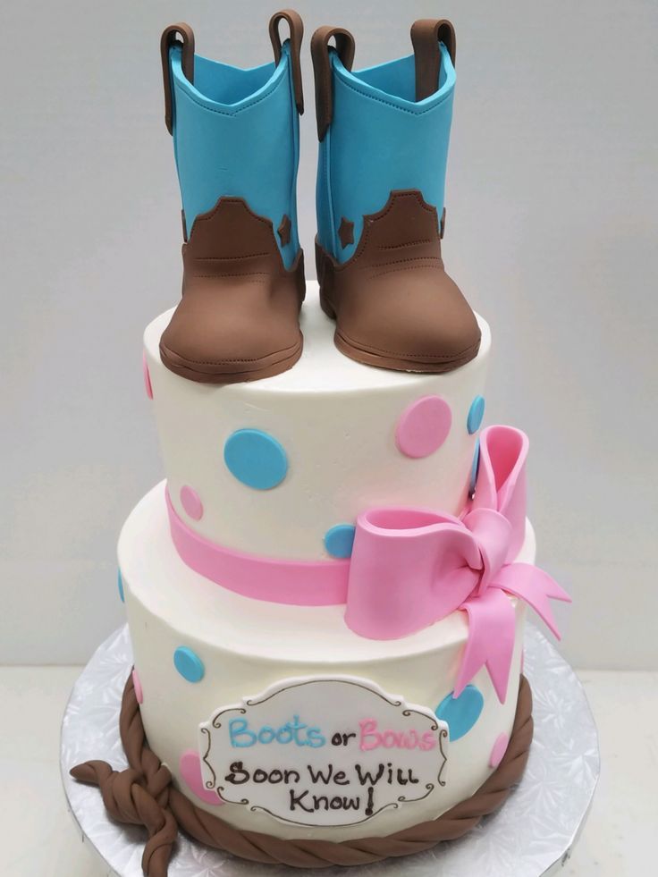 a cake decorated with boots and ribbon on top