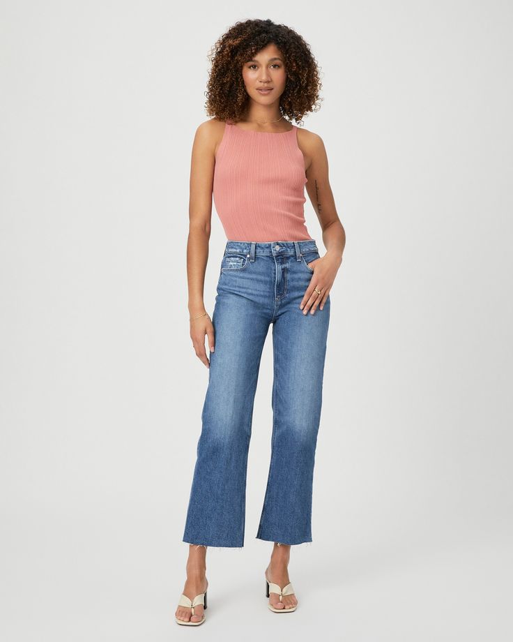 This sleek wide leg is designed with a high-rise, a flattering bow leg and an easy cropped ankle length inseam that can be paired with any shoe heel height. This pair is crafted in PAIGE VINTAGE denim with a portion of organic cotton and comes in a faded medium wash with authentic character and a raw hem. PAIGE VINTAGE takes all the work out of breaking in your favorite pair of vintage jeans. We've combined the comfort of stretch with everything you love about authentic vintage denim to create s Bow Legged, Breaking In, Carbon Footprint, Bottom Clothes, Vintage Jeans, Work Out, Vintage Denim, Wide Leg Jeans, Ankle Length