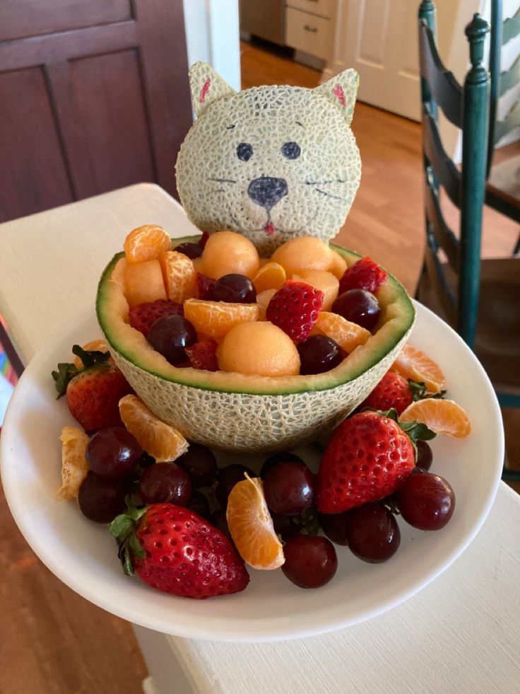 a cat made out of fruit on top of a table