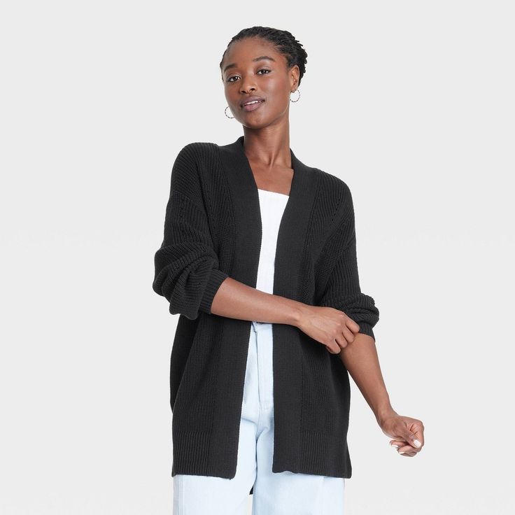 Uplift your cool-weather layering game with this Cardigan Sweater from Universal Thread™. Made from midweight cotton, this solid-color cardigan is designed in a classic shaker-knit pattern with drop-shoulder long sleeves, ribbed edges and side vents. It's tailored in a casual fit and features functional side pockets and an open front that's closure-free for easy layering. Style it with a tee, jeans and sporty shoes for a casual look, or layer it over a dress and complete the outfit with loafers Cozy Solid Cardigan For Layering, Soft Knit Relaxed Fit Cardigan For Cold Weather, Solid Color Cardigan With Ribbed Cuffs For Loungewear, Casual Textured Knit Outerwear With Relaxed Fit, Black Knit Outerwear For Loungewear, Solid Knit Outerwear For Loungewear, Casual Textured Knit Outerwear For Loungewear, Versatile Knit Outerwear With Relaxed Fit, Relaxed Fit Knit Outerwear For Cold Weather