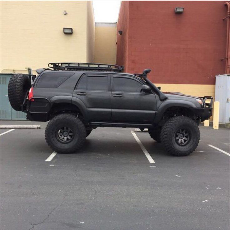 a black truck parked in a parking lot