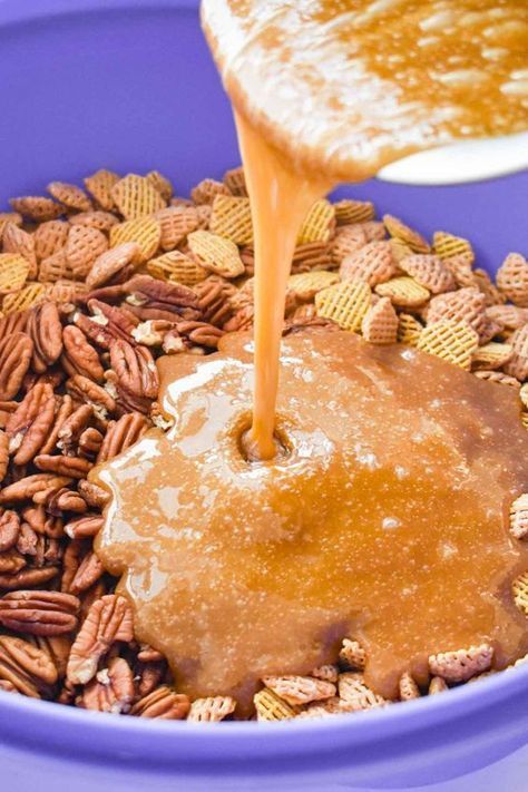 a blue bowl filled with cereal and caramel being poured into the mixture to make peanut butter pretzels