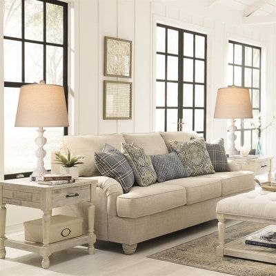 a living room filled with furniture and lots of windows