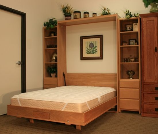 a bed sitting in a bedroom next to a book shelf