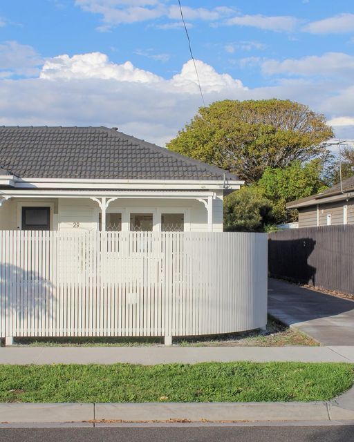 a white fence in front of a house