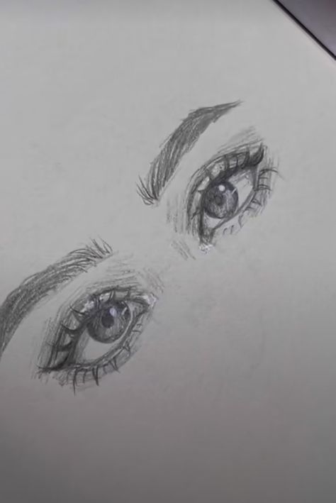 a drawing of two eyes with long lashes