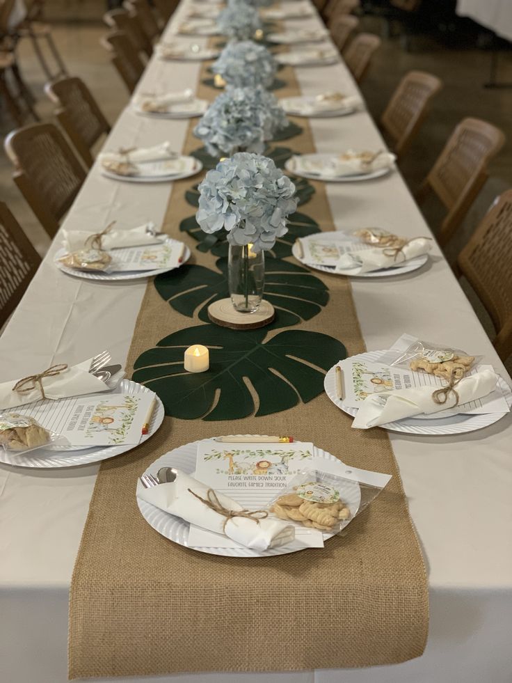 a long table with plates and place settings on it