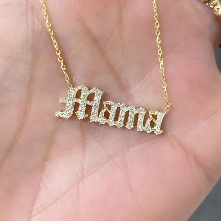 This unique personalized Old English font nameplate cut-out necklace is composed of 14K solid gold and beautifully pavé set with genuine GVs1 quality natural real Diamonds. This pendant is complemented by a durable 14K solid gold adjustable chain or can be purchased as a charm alone without the chain under the "Length" drop-down menu. NOTE: The item will be made in the exact casing of the characters entered. Please be mindful of this detail when providing the customization desired. Name Dimensio Luxury White Gold Necklaces For Mother's Day, Personalized White Diamond Necklaces, Gold Diamond Jewelry Gift For Mom, Luxury White Gold Necklace For Mother's Day, Fine Jewelry Custom Name Necklace In White Gold, Personalized White Gold Diamond Necklaces, White Gold Custom Name Necklace Fine Jewelry, Custom Name White Gold Necklace Fine Jewelry, Classic Nameplate Necklaces