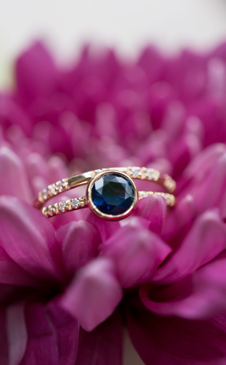 Classic style - sapphire engagement ring by S. Kind & Co. Blue Sapphire Ring With 14k Gold Round Band, Blue Sapphire Ring In 14k Gold, Blue 14k Gold Ring With Prong Setting, Sapphire Ring In Yellow Gold With Halo Setting, 14k Gold Blue Ring With Prong Setting, Blue 14k Gold Rings With Round Cut, Royal Blue Sapphire Ring Fine Jewelry, Blue Sapphire Ring With Round Band, Yellow Gold Sapphire Stackable Rings With Round Cut