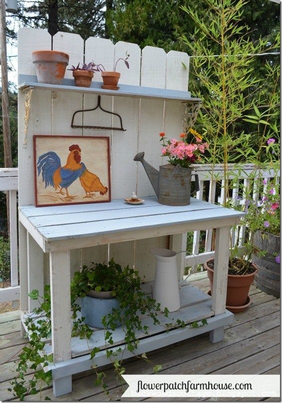 an outdoor potting station with flowers and pots on it's shelf, painted chicken