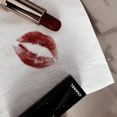 a red lipstick on top of a white towel