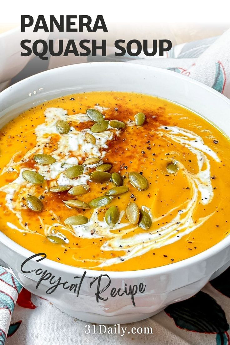 a white bowl filled with carrot soup and topped with whipped cream