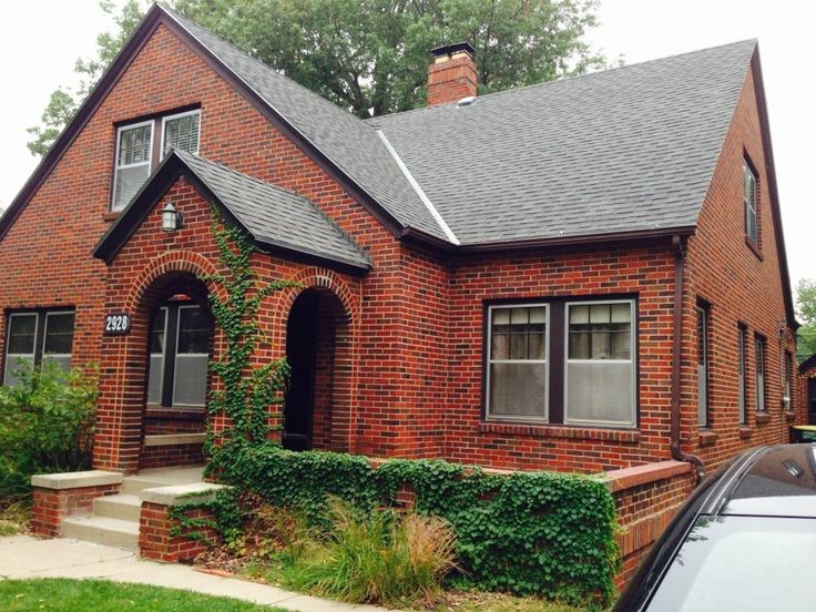 a red brick house with the words saving a homeowner's dream written on it