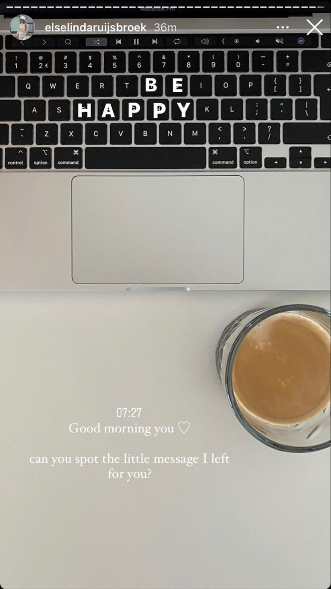 an open laptop computer sitting on top of a desk next to a cup of coffee