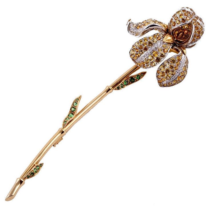 Tiffany & Co. Iris brooch in 18K yellow gold and platinum with diamonds, yellow sapphires, and tsavorite garnets. The flower has 55 round brilliant cut diamonds that total 0.60 carats, D-G color and VVS-VS clarity. The petals are studded with 239 round faceted yellow sapphires that total 20.06 carats. The leaves are set with 17 round faceted tsavorite garnets totaling 0.81 carats. The brooch comes with Tiffany & Co. box. Signed: TIFFANY & CO Diamond Flower Brooch, Jeweled Flowers, Tiffany And Co Jewelry, Tiffany Diamond, High Fashion Jewelry, Tiffany Jewelry, Antique Brooches, Diamond Brooch, Gold Brooches