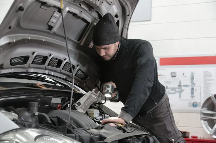 a man working on an engine in a garage