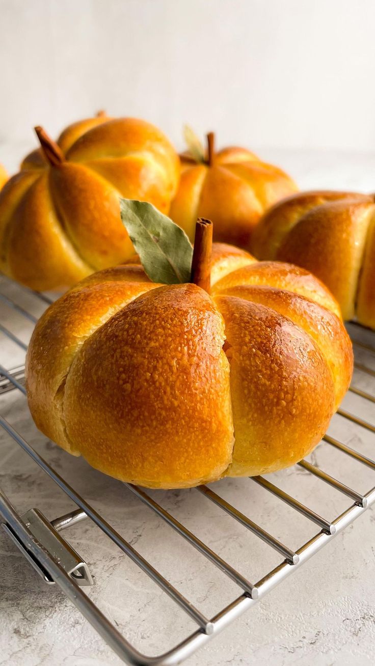 some breads are sitting on a cooling rack