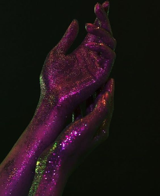 a person's hand covered in purple glitter