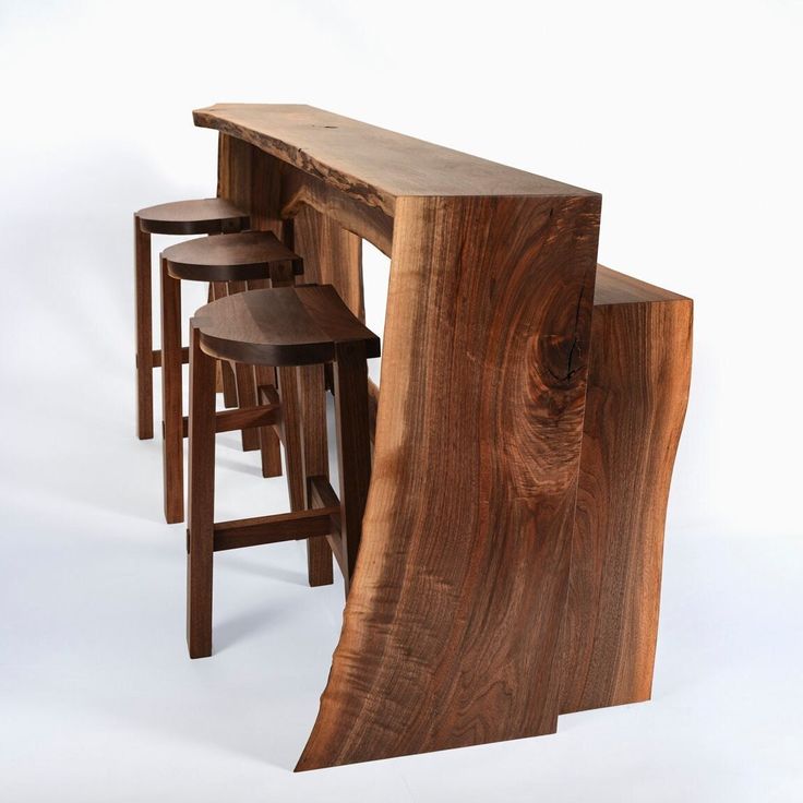 three stools and a table made out of wood