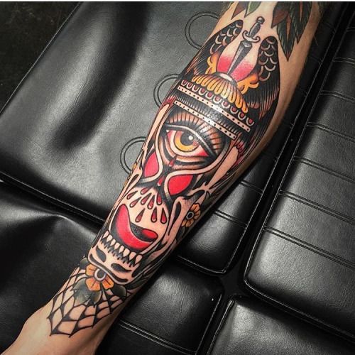 a man's leg with a tattoo on it and a skull in the middle