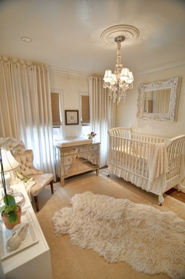 a baby's room with a crib, dresser and bed in it that has a chandelier hanging from the ceiling