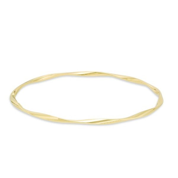 Graceful and elegant, this fashion bangle bracelet is a great day or evening wardrobe choice. Crafted in warm 14K gold, this polished design is gently twisted for a shimmering look. Wear two or more together for a bohemian chic look. Buffed to a bril Elegant Twisted Jewelry With Polished Finish, Elegant Hoop Bangle With Polished Finish, Adjustable Yellow Gold Flexible Bangle, Adjustable Flexible Yellow Gold Bangle, Modern Twist Yellow Gold Bangle Bracelet, Elegant 14k Yellow Gold Bangle, Yellow Gold Flexible Bangle Bracelet, Flexible Yellow Gold Bangle Bracelets, Adjustable Yellow Gold Bracelets With A Modern Twist