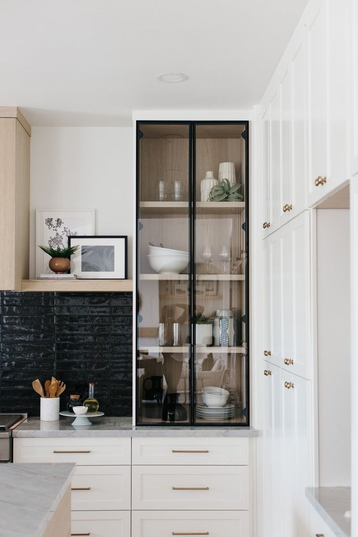 the kitchen is clean and ready to be used for cooking or baking, with white cabinets and marble countertops