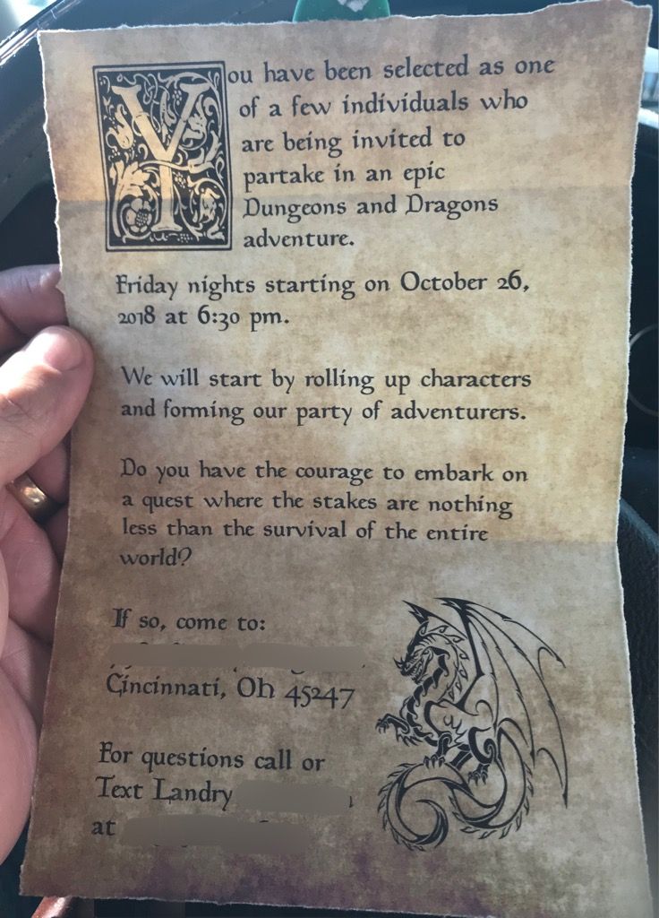 someone is holding up a piece of paper with an old style dragon on it in their hand