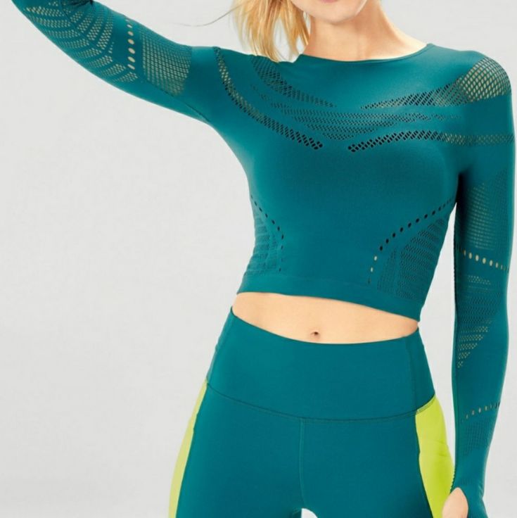 Say Hello To A Top That's Sporty Enough To Withstand Your Studio Class And Sexy Enough To Wear To The Bar. Oh And Its Soft, Yet Compressive Seamless Fabric, Supreme Breathability And Sweat-Wicking Abilities. Seamless Long Sleeve Athleisure Tops, Seamless Long Sleeve Workout Tops, Seamless Tops With Medium Support For Light Exercise, Sporty Long Sleeve Seamless Top, Green Moisture-wicking Crop Top, Green Compression Sporty Tops, High Stretch Seamless Tops For Light Exercise, Green Sportswear Tops For Yoga, Seamless Snug Fit Sports Tops