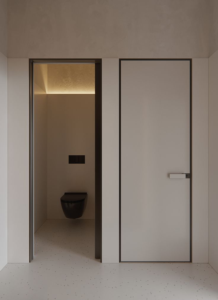 an open door leading to a toilet in a bathroom