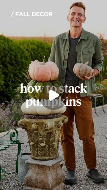 a man standing next to a large pumpkin on top of a cement planter with the words how to stack pumpkins