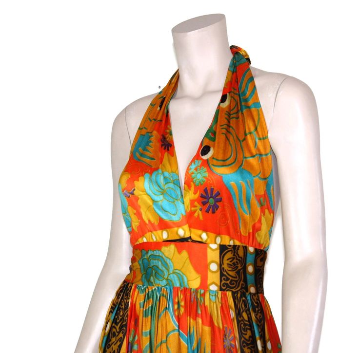 "This 60s or 70-era novelty dress features a stunning orange & black koi print fabric, adjustable halter bodice, fitted waist, and maxi length skirt. The koi fish depicted on this incredible dress are symbols of luck, wealth, and prosperity in many Eastern Asian cultures. Dress has a lined bodice and zips up the back. Best fits size xs or small (please check measurements below). Accessories not included. Payment plans available. Approximate Flat Measurements: Multiply times 2 for bust, waist Fitted Orange Halter Dress For Summer, Retro Halter Neck Summer Dress, Fitted Orange Maxi Dress For Beachwear, Vibrant Print Maxi Dress For Summer Evenings, Summer Evening Maxi Dress With Vibrant Print, Orange Maxi Length Halter Dress For Beach, Orange Maxi Length Halter Dress For Summer, Fitted Orange Halter Dress For Vacation, Bohemian Fitted Halter Evening Dress