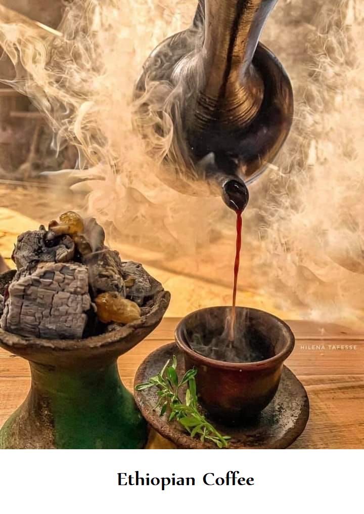 an elephant pouring tea into a cup on top of a wooden table next to other items