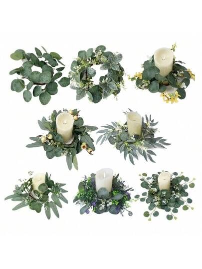 several white candles are surrounded by greenery and flowers on a white background, including eucalyptus leaves