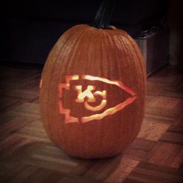 a carved pumpkin with the letter k on it