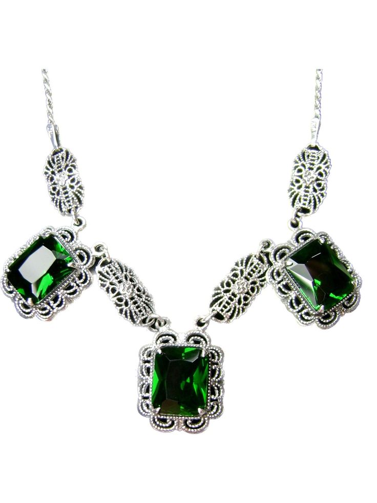 Sterling Silver NecklaceFestoon Design#P8 Introducing the Festoon Necklace P8 - a reproduction of a stunning Victorian era masterpiece! This breathtaking sterling silver filigree necklace is perfect for the jewelry connoisseur who loves and admires antique style vintage pieces. The flawless 3.5ct emerald cut gemstones are 10mm x 8mm x 5mm each, making this a truly unique and captivating piece.Each necklace is 18" long with an adjustable length as short as 16". Each one is marked 925 for sterling Formal Green Engraved Necklace, Elegant Silver Emerald Necklace With Jewels, Elegant Silver Emerald Necklace, Classic Silver Pendant Emerald Necklace, Elegant Green Engraved Jewelry, Antique Silver Necklace With Intricate Design For Formal Occasions, Formal Silver Hallmarked Emerald Necklace, Formal Antique Silver Necklace With Intricate Design, Elegant Formal Emerald Necklace With Intricate Design