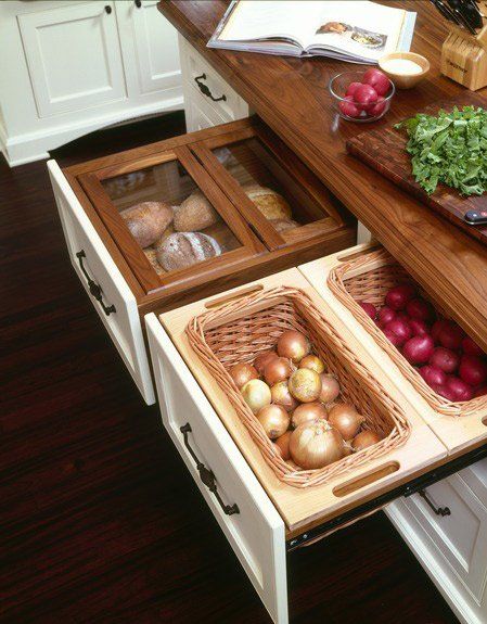 an open drawer in the middle of a kitchen counter with vegetables and other items on it