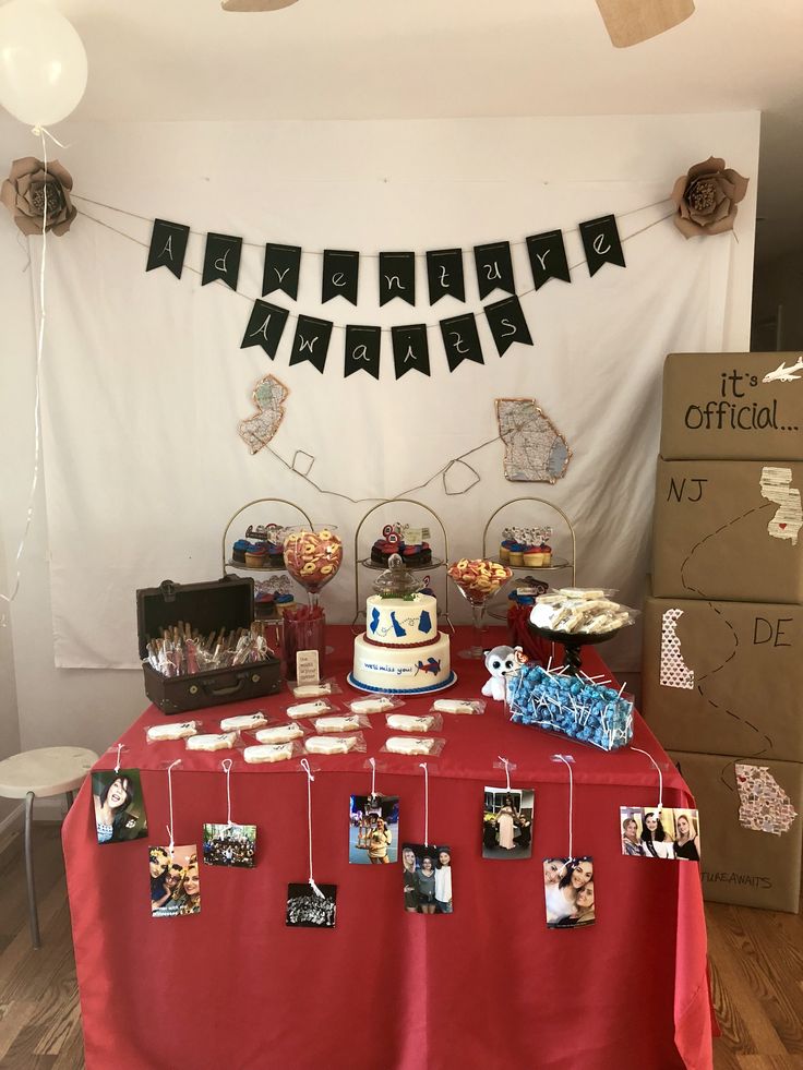 a red table topped with a cake and pictures