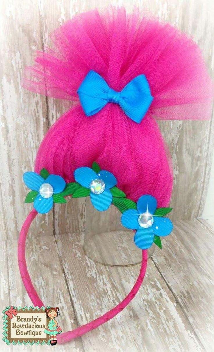 a pink headband with blue flowers on it