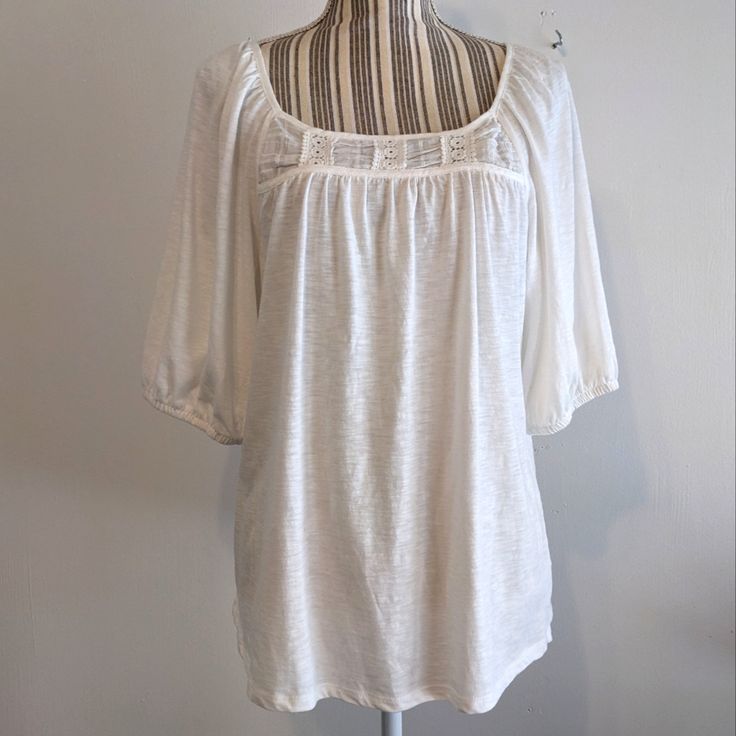 For Size Reference, This Is Modeled On A Small Mannequin, This Is Size Large, So You Can See It's Very Roomy. Smock Style With A Yolk In The Back And The Front With Light Gathering Underneath. The Sleeves Are Set In At An Angle And Are Part Of The Shoulder, Comes Down To Just About The Elbow, Loose Elastic Around The Edge. Cute Square Neckline, Loose Fit In The Body With A Boxy Shape. Cotton And Modal, White With Little Streaks Going Through It, Lightweight And Soft. Pit To Pit Is 21", Size Larg Casual Smocked Top With Gathered Neckline, Spring Short Sleeve Peasant Top With Gathered Sleeves, Casual Smocked Top With Gathered Neckline For Daywear, Casual Short Sleeve Top With Gathered Neckline, Casual Tops With Gathered Neckline And Short Sleeves, Summer Tops With Gathered Sleeves, Flowy Fit, Summer Tops With Gathered Sleeves And Flowy Fit, Billowy Summer Peasant Top With Gathered Sleeves, Casual Tops With Gathered Neckline For Spring