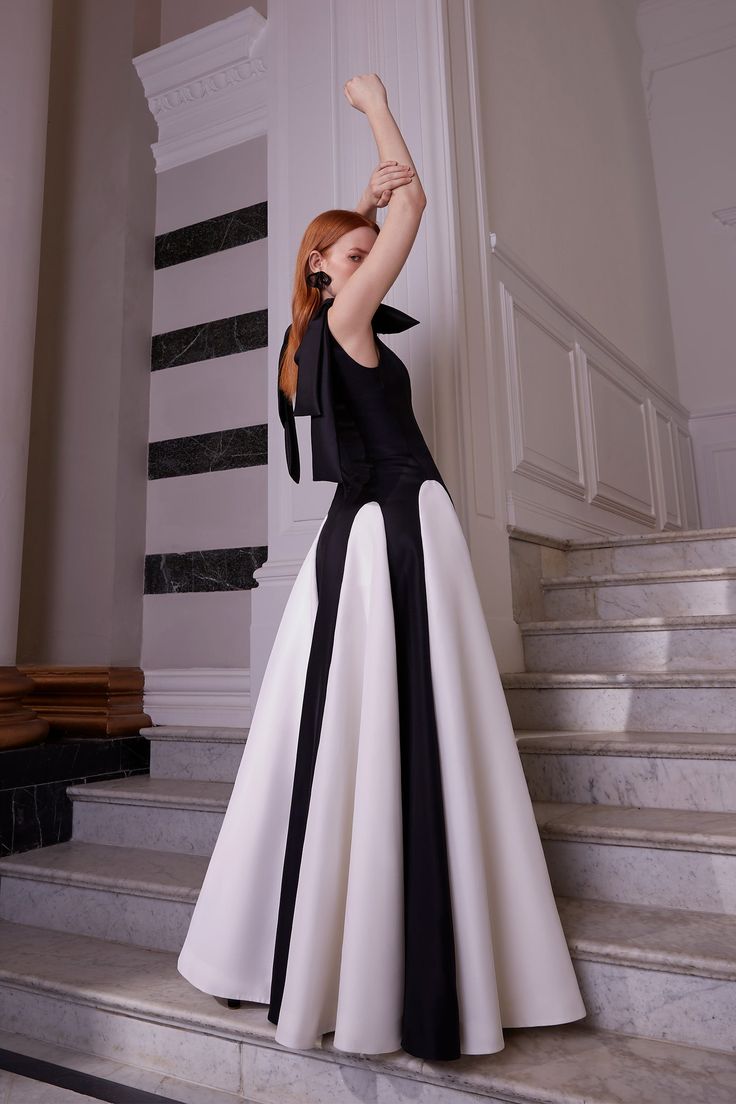 A stunning, architectural gown cut from our signature high quality Italian gazar. This wonderful special event piece is perfect for any black tie affair or could even worn as a stunning alternative wedding dress. --- - Outer: 100% Italian Silk Gazar - Lining: 100% Silk Habotai - Specialist Dry Clean Only - Made in London --- - Fits true to size - Measure your Bust, Waist and Hips against our Size Guide - Model is 5ft 10" and wears a size 8 --- Sustainable attributes: Timeless Design; Contains Natural Fibres; High Quality Italian Silk; Made in our London Atelier. To learn more about our sustainability commitments please click here: Suzannah London - Sustainability Architectural Gown, Suzannah London, Structured Gown, Alternative Wedding Dress, Godet Dress, Evening Fashion, Sculptural Fashion, Alternative Wedding Dresses, Black Tie Affair