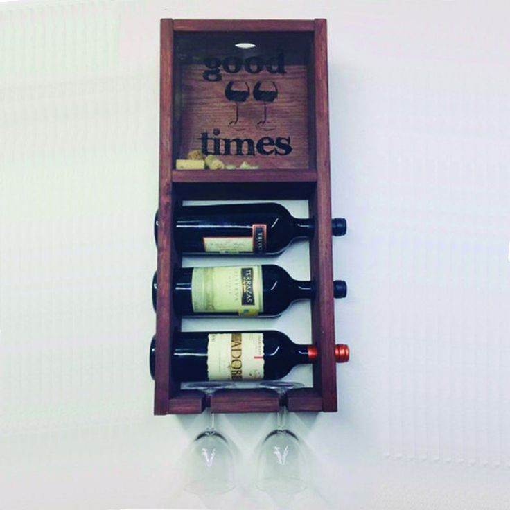 a wooden wine rack with four bottles in it and the words good times written on it